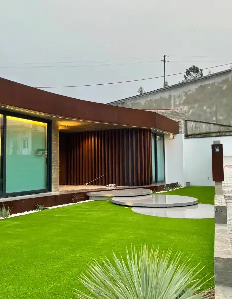 Jardim de moradia contemporânea com relva sintética e pátio interior — resultado final