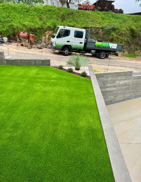 Jardim de moradia contemporânea com relva sintética e pátio interior — resultado final