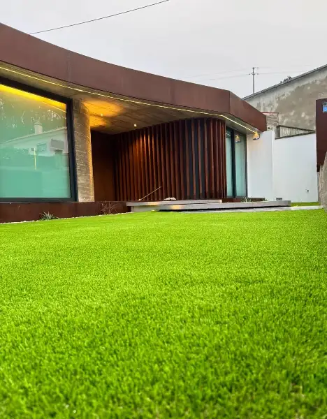Jardim de moradia contemporânea com relva sintética e pátio interior — resultado final